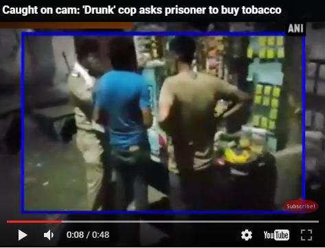 Drunk Policeman and prisoner buying tobacco in Uttar Pradesh's Etah