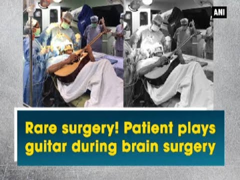 Man plays guitar in operation theater during brain surgery