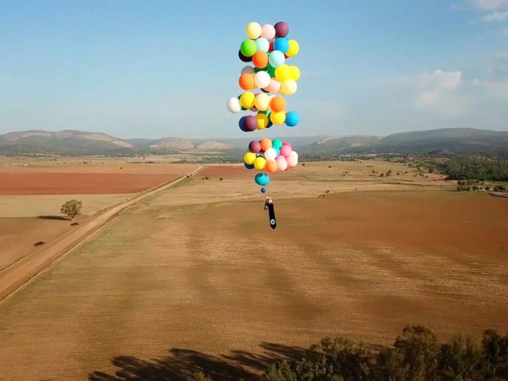 Man flies over South Africa in a chair tied to helium balloons, inspired by a movie