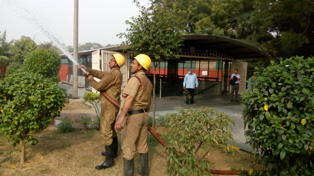Fire tenders sprinkle water on trees to control pollution in Delhi