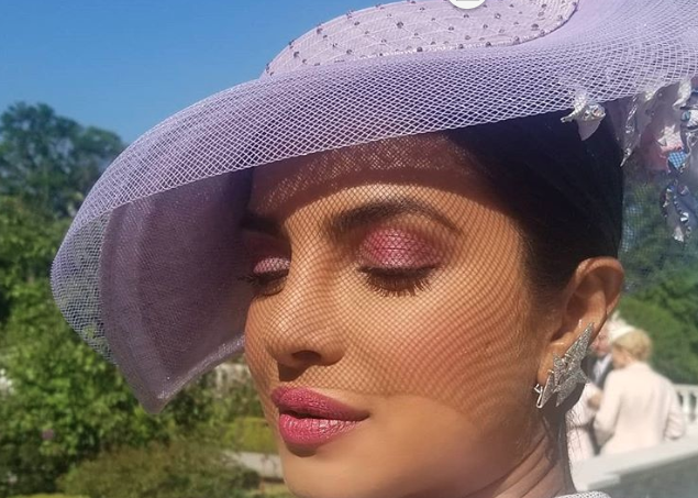 Priyanka arrives for the royal wedding dressed in lavender and we are awestruck !