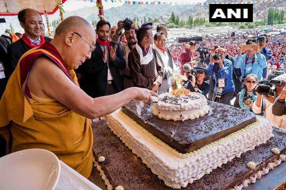 His Holiness the Dalai Lama cuts a cake on his 83rd birthday