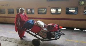 Lady Coolie carrying the luggage at Bhavnagar Railway station in Gujarat