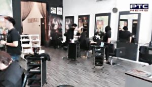 Salon owner cuts customers' hair with gold scissors